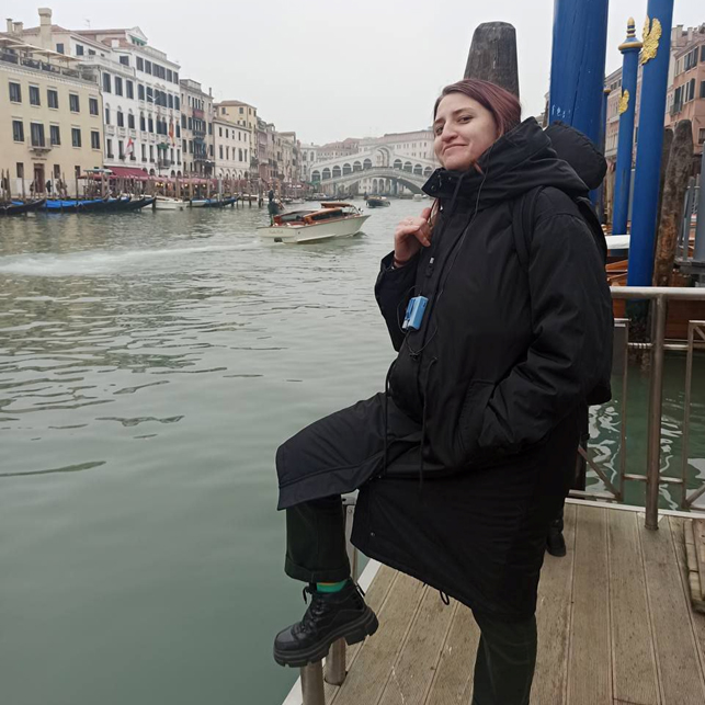 You can see a percen called Alia standing in front of a canal in Venice.